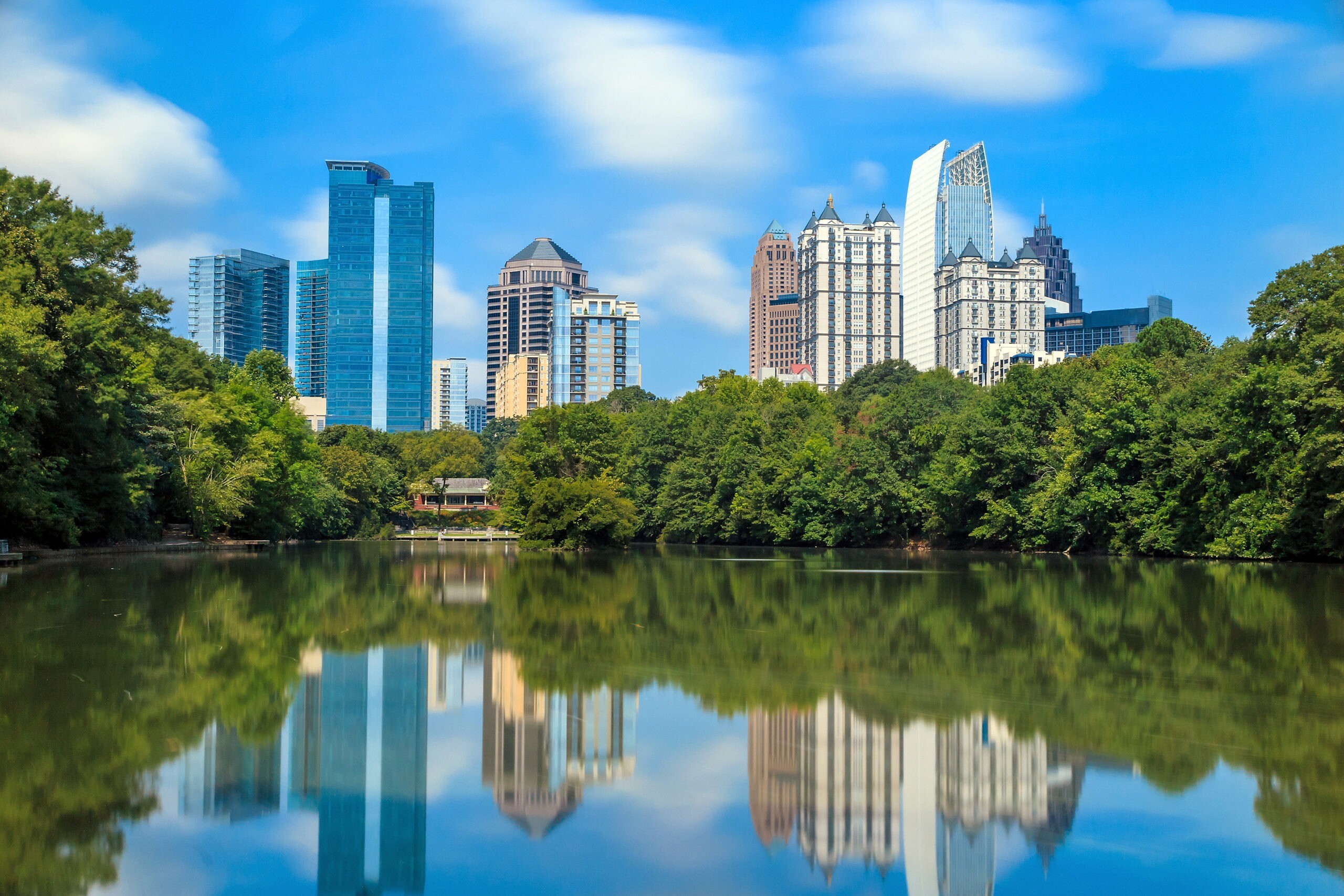 atlanta ga Skyline and reflections of midtown Atlanta, Georgia in Lake Meer from Piedmont Park.